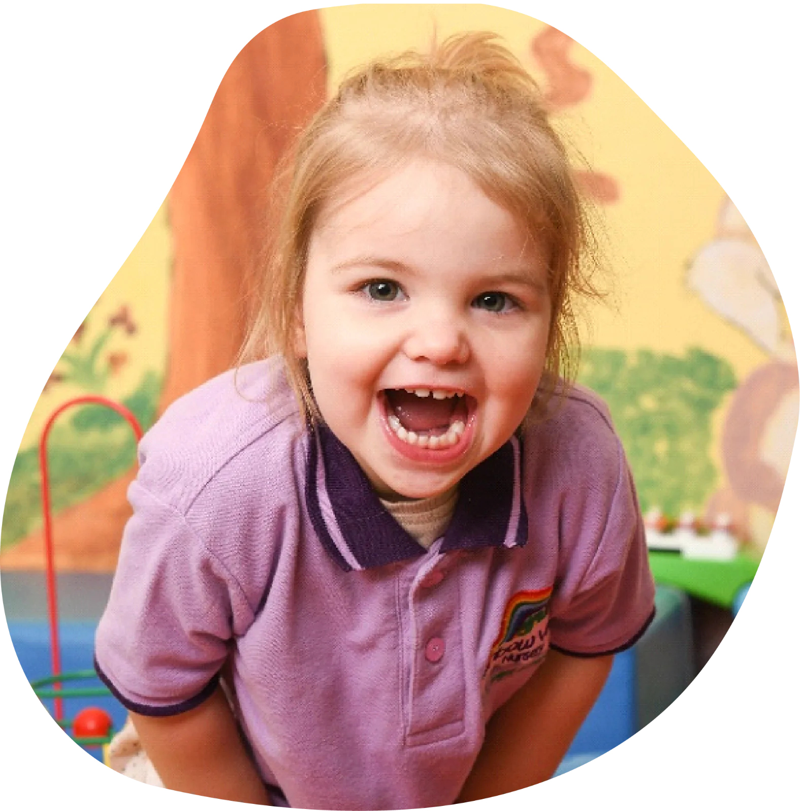 Happy toddler in nursery uniform smiling