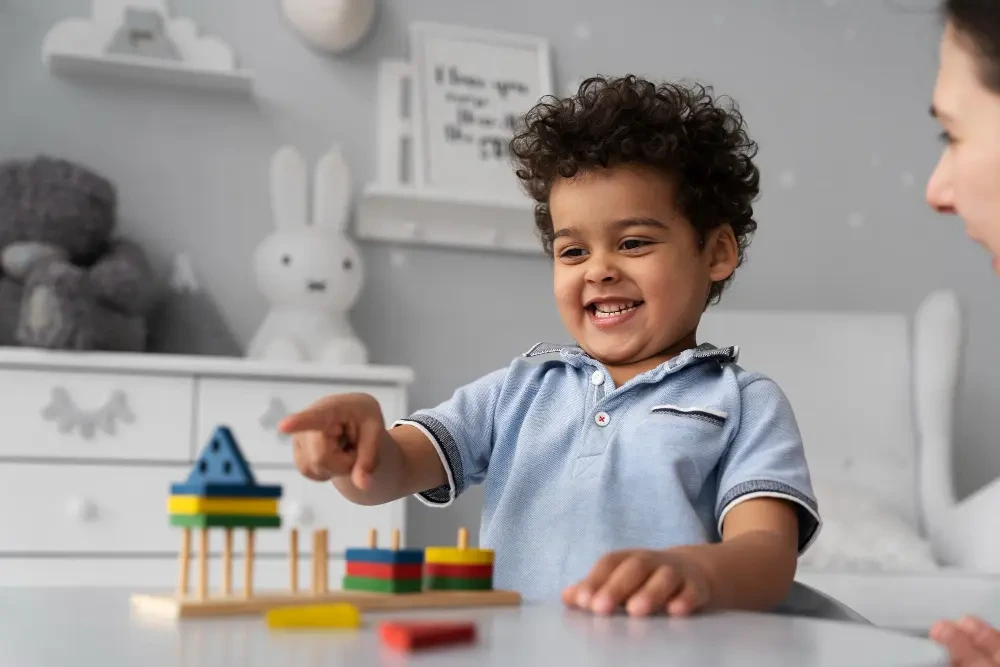 Smiling toddler playing with wooden stacking toys